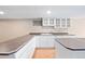 Well-lit kitchen with white cabinetry, modern appliances, and countertop space at 6150 Reed St, Arvada, CO 80003