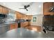 Kitchen features stainless steel appliances, wood cabinetry, and backsplash at 6150 Reed St, Arvada, CO 80003