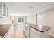 Bright kitchen area with island cooktop and a sliding door leading to backyard at 6150 Reed St, Arvada, CO 80003