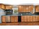 Kitchen featuring stainless steel appliances, wood cabinets and flooring at 6150 Reed St, Arvada, CO 80003