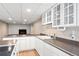 Kitchen with ample counter space, recessed lighting, and view of the fireplace at 6150 Reed St, Arvada, CO 80003