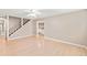 Open living room area with hardwood floors and access to staircase at 6150 Reed St, Arvada, CO 80003