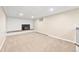 Cozy living room with a white brick fireplace and neutral carpeting at 6150 Reed St, Arvada, CO 80003