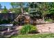 Picturesque backyard pond with a cascading waterfall feature and lush landscaping at 6150 Reed St, Arvada, CO 80003
