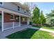 Inviting covered front porch, perfect for relaxing, complements the charming brick and siding exterior at 6150 Reed St, Arvada, CO 80003
