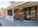 Close up of a charming brick porch featuring a ceiling fan and a convenient access point at 6150 Reed St, Arvada, CO 80003