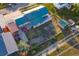 An aerial view of the home showcases the green metal roof, back deck, outbuildings, and large yard at 470 Mcdonnell St, Byers, CO 80103