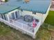Aerial view of the backyard deck featuring a hot tub and an outdoor dining area with an umbrella at 470 Mcdonnell St, Byers, CO 80103