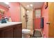 Bathroom featuring a glass enclosed shower, vanity with sink, and decorative accents at 470 Mcdonnell St, Byers, CO 80103