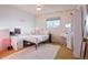 Bright bedroom featuring carpeted floors, a large window, and furniture at 470 Mcdonnell St, Byers, CO 80103