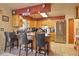 Functional kitchen with bar seating, wood cabinets, stainless steel appliances, and tile floor at 470 Mcdonnell St, Byers, CO 80103