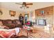 Inviting living room featuring a stone fireplace, wood floors and comfortable seating at 470 Mcdonnell St, Byers, CO 80103