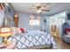 Comfortable main bedroom with blue walls, ceiling fan, wood floors and ensuite bathroom at 470 Mcdonnell St, Byers, CO 80103