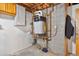 Unfinished utility area showcasing the efficient hot water heater, plumbing, and electrical systems at 470 Mcdonnell St, Byers, CO 80103