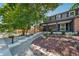 Two-story home with gray siding, landscaping, and a covered porch at 7910 E Bethany Pl, Denver, CO 80231