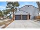 Two-car attached garage with gray doors and brick exterior at 7910 E Bethany Pl, Denver, CO 80231