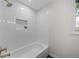 Clean bathroom with a bathtub and shower combination at 7910 E Bethany Pl, Denver, CO 80231