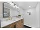 Modern bathroom with double vanity, marble countertop and walk-in shower at 7910 E Bethany Pl, Denver, CO 80231