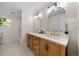 Modern bathroom with double vanity and walk-in shower at 7910 E Bethany Pl, Denver, CO 80231