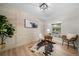 Home office with wood-look floors, cowhide rug and stylish decor at 7910 E Bethany Pl, Denver, CO 80231