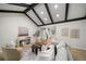 Open concept living room with hardwood floors and view into kitchen at 7910 E Bethany Pl, Denver, CO 80231