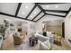 Bright living room with vaulted ceiling, hardwood floors, and a view into the kitchen at 7910 E Bethany Pl, Denver, CO 80231