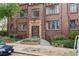 Classic brick apartment building entrance with beautiful landscaping and sidewalk at 1060 N Washington St # 1A, Denver, CO 80203