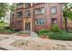 Charming brick apartment building entrance featuring beautiful landscaping and classic architectural details at 1060 N Washington St # 1A, Denver, CO 80203