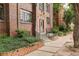 Brick building entrance with decorative stonework, tidy landscaping, and a secure entry at 1060 N Washington St # 1A, Denver, CO 80203
