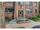 Charming brick building entrance featuring decorative stonework, landscaping, and a secure entry at 1060 N Washington St # 1A, Denver, CO 80203