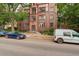 Brick building facade and surrounding greenery with nearby street parking available at 1060 N Washington St # 1A, Denver, CO 80203
