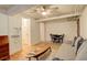 Cozy living room featuring hardwood floors, a ceiling fan, and a comfortable gray couch at 1060 N Washington St # 1A, Denver, CO 80203