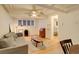Cozy living room featuring a ceiling fan, hardwood floors, and a view to the bedroom at 1060 N Washington St # 1A, Denver, CO 80203
