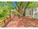 Expansive backyard deck area with bench seating, shade tree and backyard access at 3266 S Wabash Ct, Denver, CO 80231