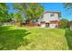 Large backyard with spacious lawn, patio area and wooden deck seating at 3266 S Wabash Ct, Denver, CO 80231