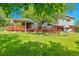 A spacious backyard featuring a large wooden deck and patio set, perfect for outdoor entertaining at 3266 S Wabash Ct, Denver, CO 80231
