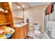 Bathroom featuring a vanity, a toilet, and a shower with glass door at 3266 S Wabash Ct, Denver, CO 80231