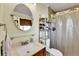 Bathroom featuring a vanity, round mirror and a shower with a white curtain at 3266 S Wabash Ct, Denver, CO 80231