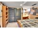 Cozy bedroom featuring a large closet, carpet and unique wall design at 3266 S Wabash Ct, Denver, CO 80231