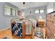 Cozy bedroom with hardwood floors, brass bed frame, and windows with natural light at 3266 S Wabash Ct, Denver, CO 80231