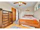 Bedroom featuring hardwood floors, a bed with quilt, wood dresser, and natural light at 3266 S Wabash Ct, Denver, CO 80231