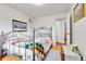 Bedroom with wood floors, metal bed frame, and view into hallway at 3266 S Wabash Ct, Denver, CO 80231