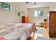 Bedroom featuring a window, wood floors, and an antique wood dresser at 3266 S Wabash Ct, Denver, CO 80231