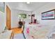 Bright bedroom featuring hardwood floors, a metal bed frame, and closet at 3266 S Wabash Ct, Denver, CO 80231