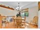 Bright dining room features hardwood floors and a round table with seating for cozy meals at 3266 S Wabash Ct, Denver, CO 80231