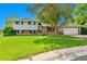 Charming two-story home with a well-manicured lawn and mature landscaping, creating inviting curb appeal at 3266 S Wabash Ct, Denver, CO 80231