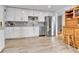 Stylish kitchen with white cabinets, stainless steel appliances, and hardwood floors for a modern look at 3266 S Wabash Ct, Denver, CO 80231