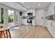 Modern kitchen with white cabinets, stainless steel appliances, and a door leading to the backyard at 3266 S Wabash Ct, Denver, CO 80231
