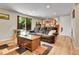 Living room with wood floors, reclining couch, and walk-out to backyard at 3266 S Wabash Ct, Denver, CO 80231