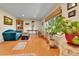 Spacious living room with hardwood floors, a large window, and cozy seating for comfortable living at 3266 S Wabash Ct, Denver, CO 80231